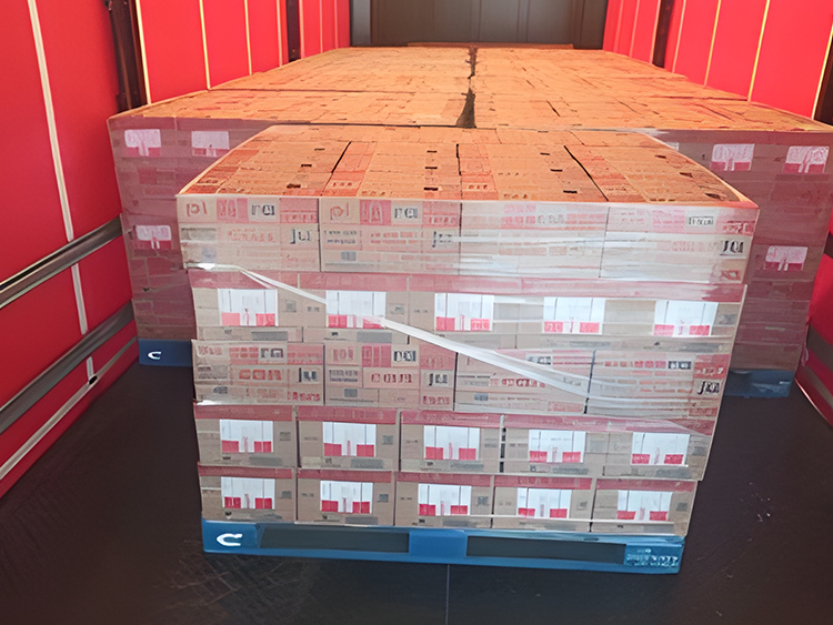 Paletes com caixas organizadas e filmadas dentro do baú de um caminhão, prontas para entrega ao destino final.